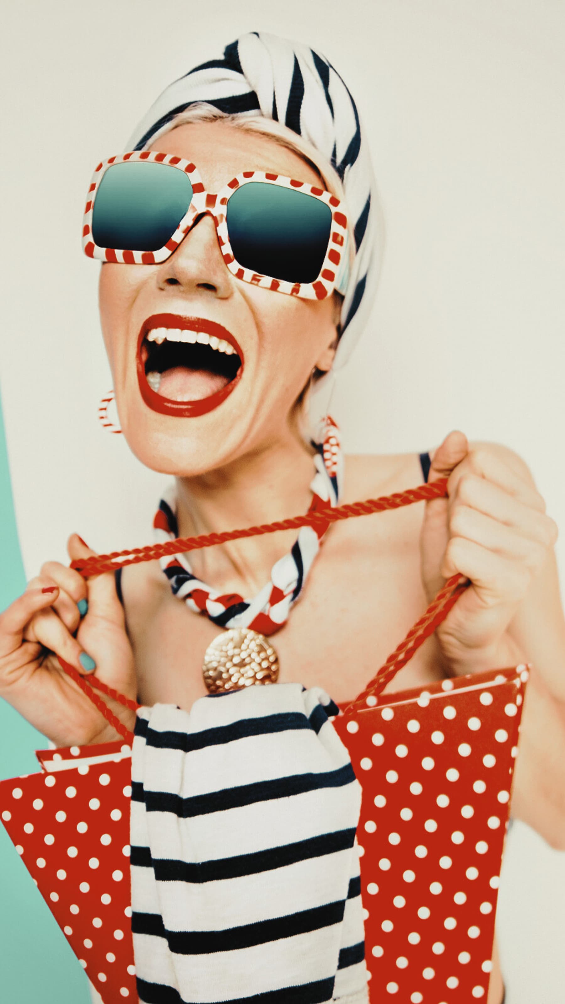 Woman wearing bold sunglasses and playful summer styling for the Baba Yaga Summer campaign.