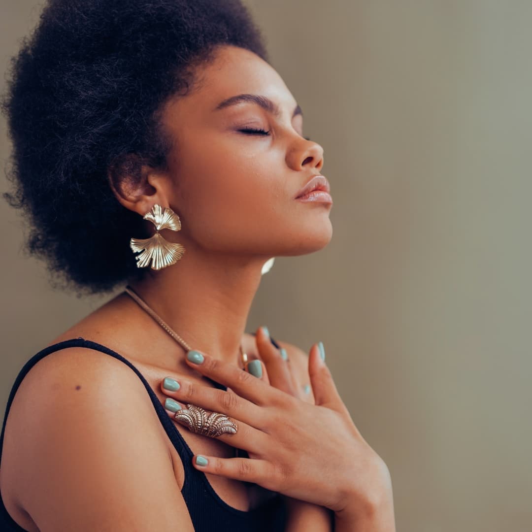 Woman practicing self-care and reflection, showing how a menstrual cycle coach supports emotional well-being.