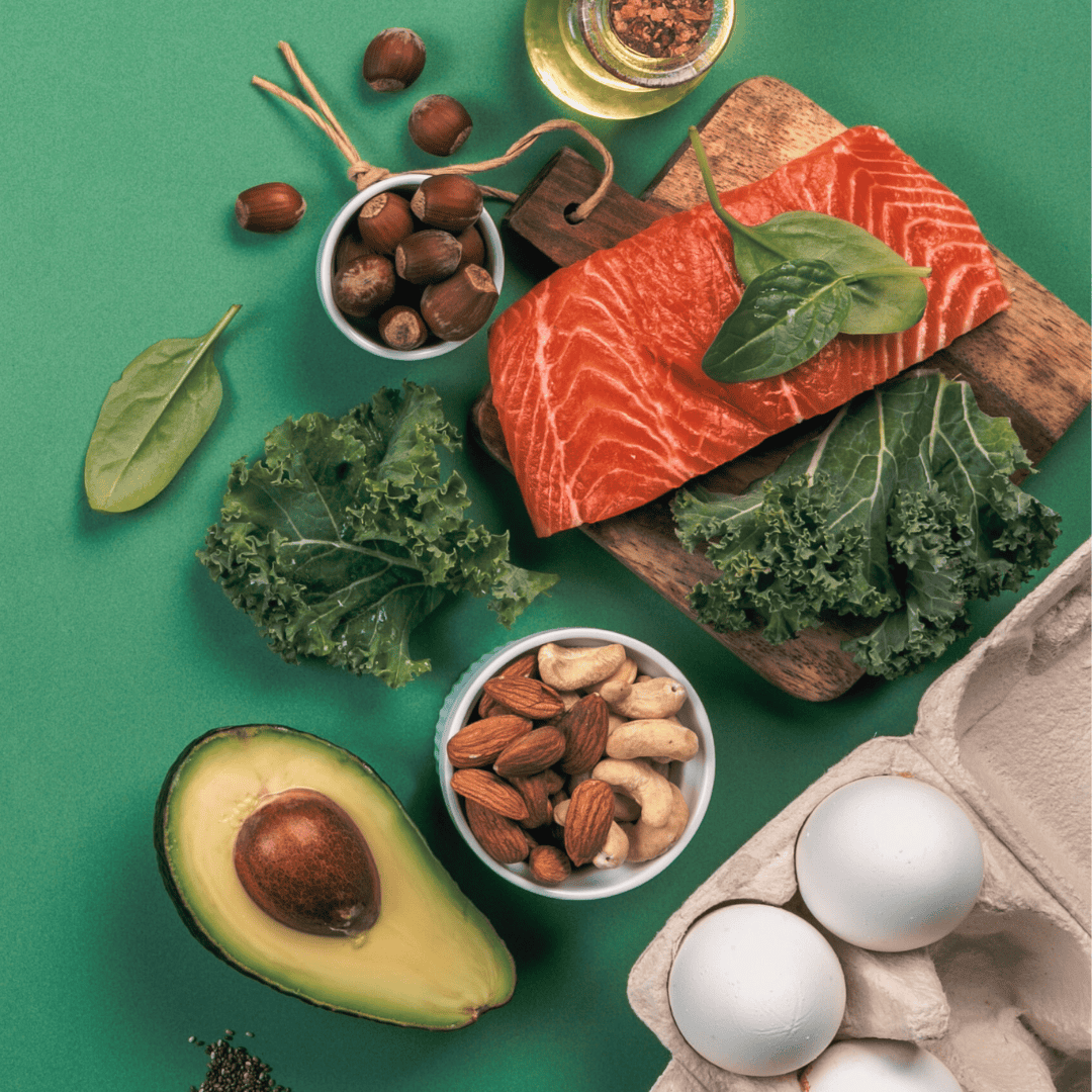 Healthy spread of anti-inflammatory foods with salmon, avocado, nuts, and eggs.