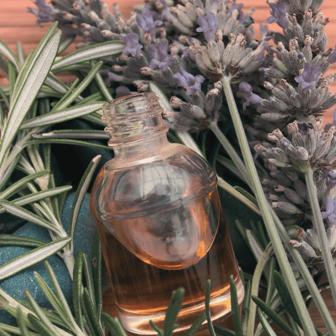 Glass bottle with lavender and rosemary essential oil.