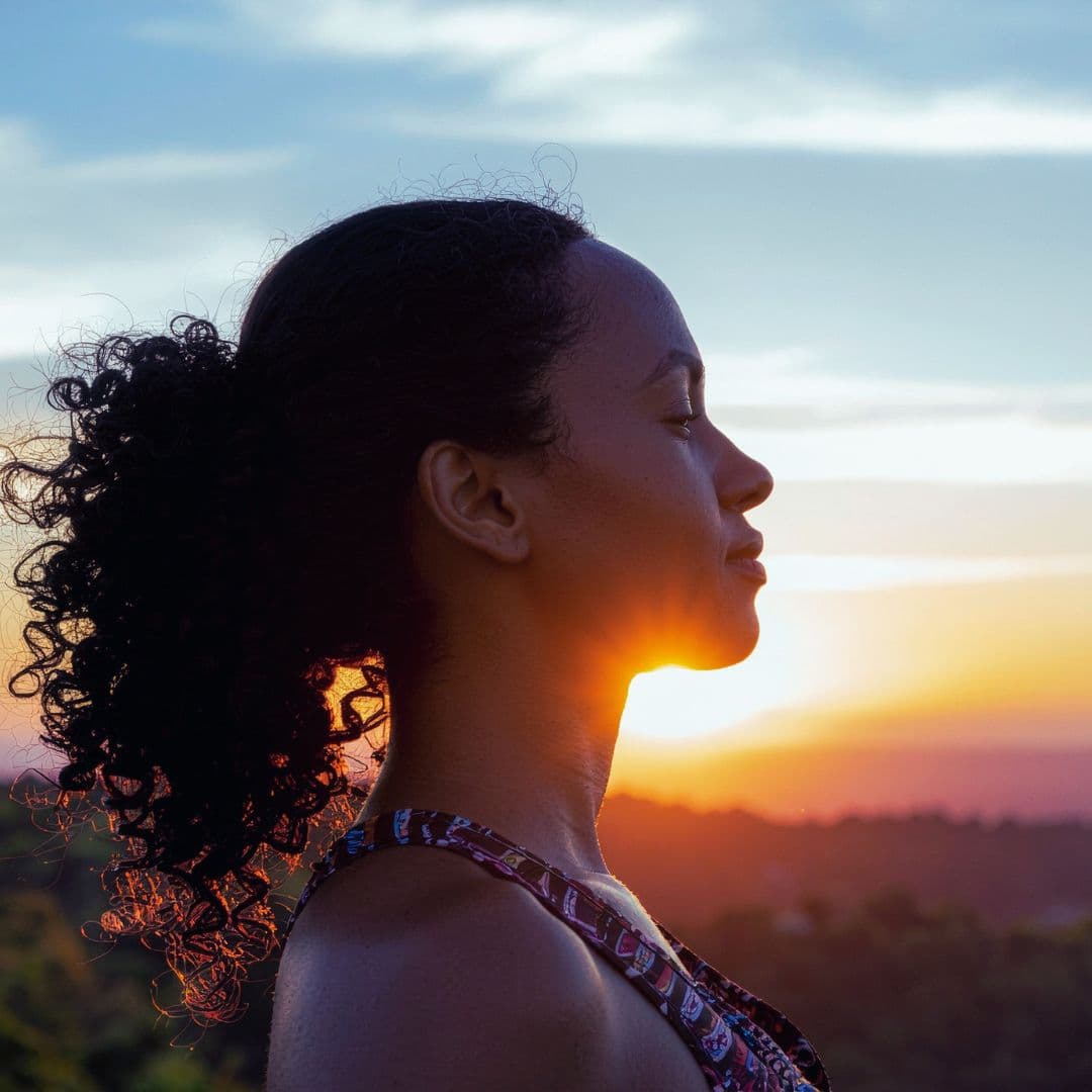 woman’s healthy habit of meditating at sunrise
