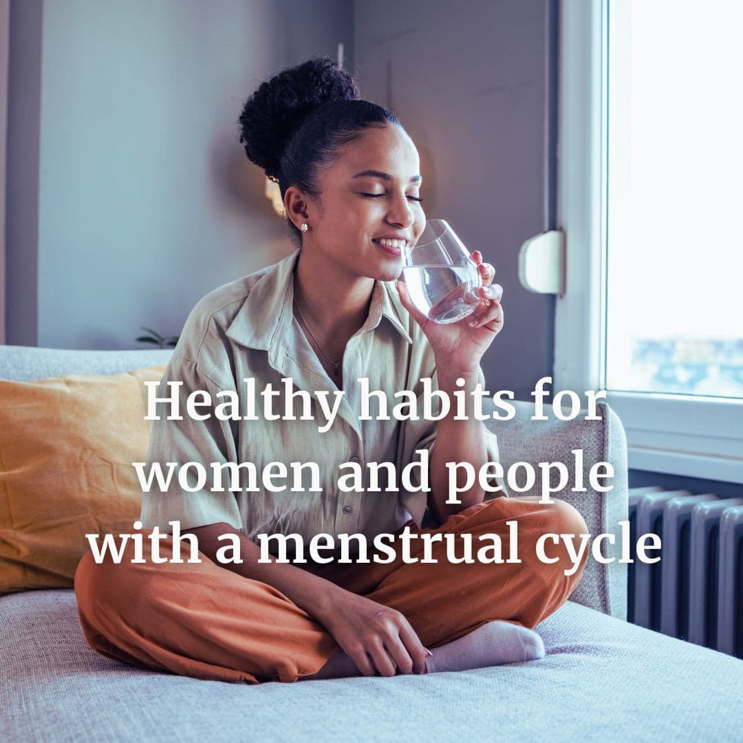 relaxed woman cultivating the healthy habit of drinking a glass of water first thing in the morning.